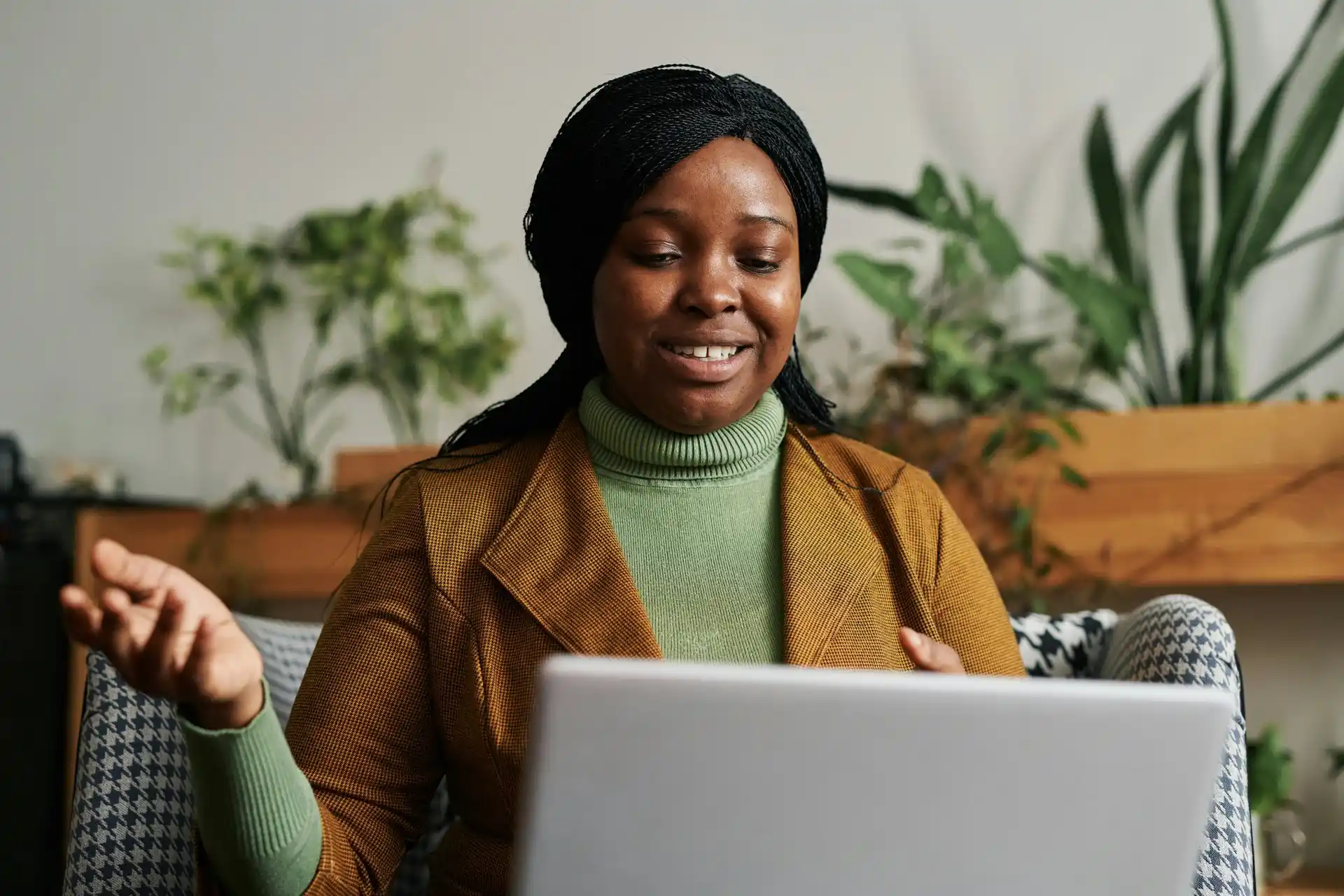 Person having a telehealth therapy session on laptop