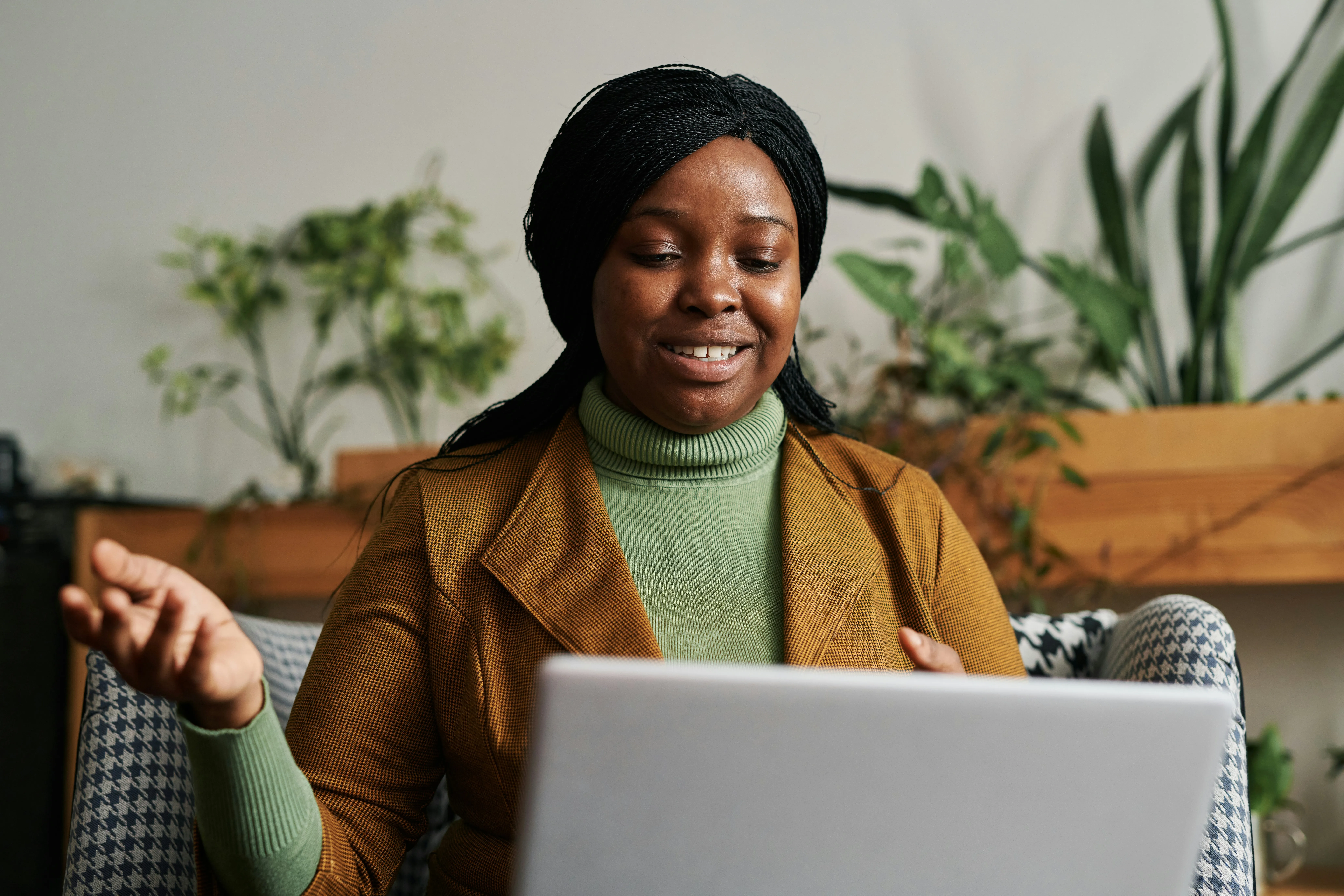 Person having a telehealth therapy session on laptop